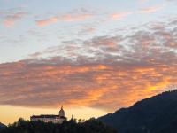 Verstärktes orangefarbenes Leuchten an Wolkenschicht über Schloß Hohenaschau